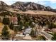 Aerial view of a house featuring a lush landscape, solar panels and mountain views at 3970 Longwood Ave, Boulder, CO 80305