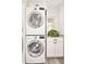 Bright laundry room with stackable washer and dryer and a decorative accent wall at 3970 Longwood Ave, Boulder, CO 80305