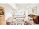 Sunlit living room featuring a cozy sofa, piano, and stylish floral armchairs at 3970 Longwood Ave, Boulder, CO 80305
