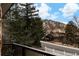 Home with mountain views framed by mature trees and a white picket fence at 3970 Longwood Ave, Boulder, CO 80305