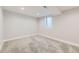 Spacious finished basement with neutral carpeting and a large window, perfect for storage or a recreation room at 6635 S Sherman St, Centennial, CO 80121