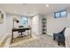 Finished basement office with a modern desk, blue accent chair, and ample natural light at 6635 S Sherman St, Centennial, CO 80121