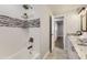 Bathtub features white tiled walls with decorative mosaic accents and modern fixtures at 6635 S Sherman St, Centennial, CO 80121