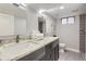 Updated bathroom with granite countertop, double sinks, and modern fixtures with tiled floors at 6635 S Sherman St, Centennial, CO 80121