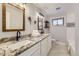 Bright bathroom features a double vanity with granite counters and stylish wood-framed mirrors at 6635 S Sherman St, Centennial, CO 80121