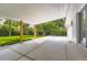 Spacious covered patio with concrete flooring and wooden support beams, offering ample outdoor living space at 6635 S Sherman St, Centennial, CO 80121