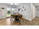 Cozy dining area featuring a modern chandelier, stylish furnishings, and natural light through the glass doors at 6635 S Sherman St, Centennial, CO 80121