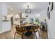 Cozy dining area featuring a modern chandelier, stylish furnishings, and natural light through the glass doors at 6635 S Sherman St, Centennial, CO 80121