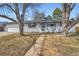 Charming single-Gathering home with a brick facade, inviting entryway, and well-maintained lawn at 6635 S Sherman St, Centennial, CO 80121