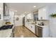 Modern kitchen featuring white cabinets, stainless steel appliances, and sleek granite countertops at 6635 S Sherman St, Centennial, CO 80121