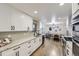 Spacious updated kitchen with granite counters, stainless appliances, hardwood flooring and dining area at 6635 S Sherman St, Centennial, CO 80121