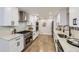 Modern kitchen featuring white cabinets, stainless steel appliances, and sleek granite countertops at 6635 S Sherman St, Centennial, CO 80121