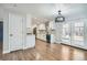 Bright, modern kitchen with white cabinets, stainless steel appliances, and beautiful hardwood floors at 6635 S Sherman St, Centennial, CO 80121