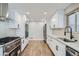 Bright kitchen with modern appliances, white cabinets, granite counters, and sleek stainless steel fixtures at 6635 S Sherman St, Centennial, CO 80121