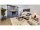 Inviting living room with stylish wood accent wall, modern fireplace, and neutral-toned decor at 6635 S Sherman St, Centennial, CO 80121
