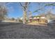 Expansive backyard featuring mature trees providing shade, a tidy lawn, and a storage shed at 2925 S Ingalls Way, Denver, CO 80227