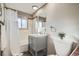 Bathroom with a bathtub, shower and vanity with a grey cabinet at 2925 S Ingalls Way, Denver, CO 80227