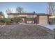 Well-maintained home showcasing a brick facade, tidy front lawn, and attached garage at 2925 S Ingalls Way, Denver, CO 80227