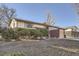 Charming two-story home with a brick facade, mature landscaping, and a well-maintained lawn at 2925 S Ingalls Way, Denver, CO 80227