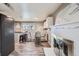 Open kitchen and dining area with modern appliances, tile floors, and a fireplace at 2925 S Ingalls Way, Denver, CO 80227