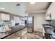 Bright kitchen with stainless steel refrigerator, functional island, and a sink with updated gray backsplash at 2925 S Ingalls Way, Denver, CO 80227