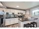 Charming kitchen featuring a stainless steel refrigerator, stylish bar seating, and modern appliances at 2925 S Ingalls Way, Denver, CO 80227