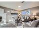 Cozy living room with a fireplace, comfortable seating, and a large window offering natural light at 2925 S Ingalls Way, Denver, CO 80227