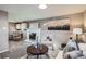 Warm living room featuring a decorative fireplace, ample seating, and an adjacent dining area at 2925 S Ingalls Way, Denver, CO 80227