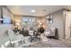 Comfortable living room with a stylish sofa, two armchairs, and a view of the outdoors at 2925 S Ingalls Way, Denver, CO 80227