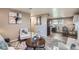Inviting living room showcasing a fireplace, comfortable furnishings, and seamless flow into the kitchen area at 2925 S Ingalls Way, Denver, CO 80227