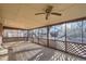 Spacious screened-in porch perfect for enjoying the outdoors with ceiling fan and lattice details at 2925 S Ingalls Way, Denver, CO 80227