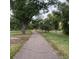Picturesque walking path surrounded by trees and greenery, perfect for a stroll or jog at 2925 S Ingalls Way, Denver, CO 80227