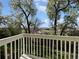 Balcony view of lush green trees and distant buildings under a beautiful sky at 2418 W 82Nd Pl # D, Westminster, CO 80031