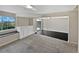 Partially finished basement with gray carpet, black tile, a window, and sliding glass doors to outside at 2418 W 82Nd Pl # D, Westminster, CO 80031