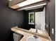 Bathroom features a double sink vanity, stylish mirror, and dark-painted walls at 2418 W 82Nd Pl # D, Westminster, CO 80031