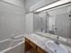 Bathroom features a soaking tub, marble countertop, and white tiled walls at 2418 W 82Nd Pl # D, Westminster, CO 80031