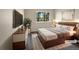 Staged bedroom featuring a plush bed, modern furniture, and a bright window view at 2418 W 82Nd Pl # D, Westminster, CO 80031