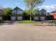 Charming townhomes featuring a brick facade, two-car garage and green landscaping at 2418 W 82Nd Pl # D, Westminster, CO 80031