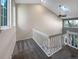 Bright hallway with white railings, skylight, and window offering natural light at 2418 W 82Nd Pl # D, Westminster, CO 80031