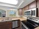 Kitchen with stainless steel appliances and a view into the living room and outside at 2418 W 82Nd Pl # D, Westminster, CO 80031