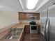 Updated kitchen featuring stainless steel appliances, wood cabinets, and a sink at 2418 W 82Nd Pl # D, Westminster, CO 80031