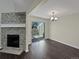 Living room featuring a stylish stone fireplace, wood floors, and sliding glass door to a private deck at 2418 W 82Nd Pl # D, Westminster, CO 80031