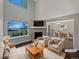 Bright living room with stone fireplace, large windows, and an open floor plan to the dining area at 2418 W 82Nd Pl # D, Westminster, CO 80031