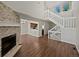 Bright and spacious living room featuring a stone fireplace, staircase and an open view to the kitchen at 2418 W 82Nd Pl # D, Westminster, CO 80031