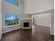 Bright and airy living room with a stone fireplace, hardwood floors and view to dining room at 2418 W 82Nd Pl # D, Westminster, CO 80031