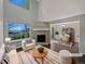 Bright living room with stone fireplace, large windows, and views of the outside at 2418 W 82Nd Pl # D, Westminster, CO 80031