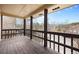 This is an outdoor balcony with dark wood floors and railings with a view of the neighborhood at 395 Raspberry Ln, Monument, CO 80132