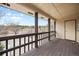 This is an outdoor balcony with dark wood floors and railings at 395 Raspberry Ln, Monument, CO 80132