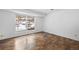 Bedroom with hardwood-style floors and a window overlooking the outdoor landscape at 395 Raspberry Ln, Monument, CO 80132