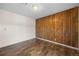 Cozy bedroom with wood-paneled accent wall and stylish laminate floors at 395 Raspberry Ln, Monument, CO 80132